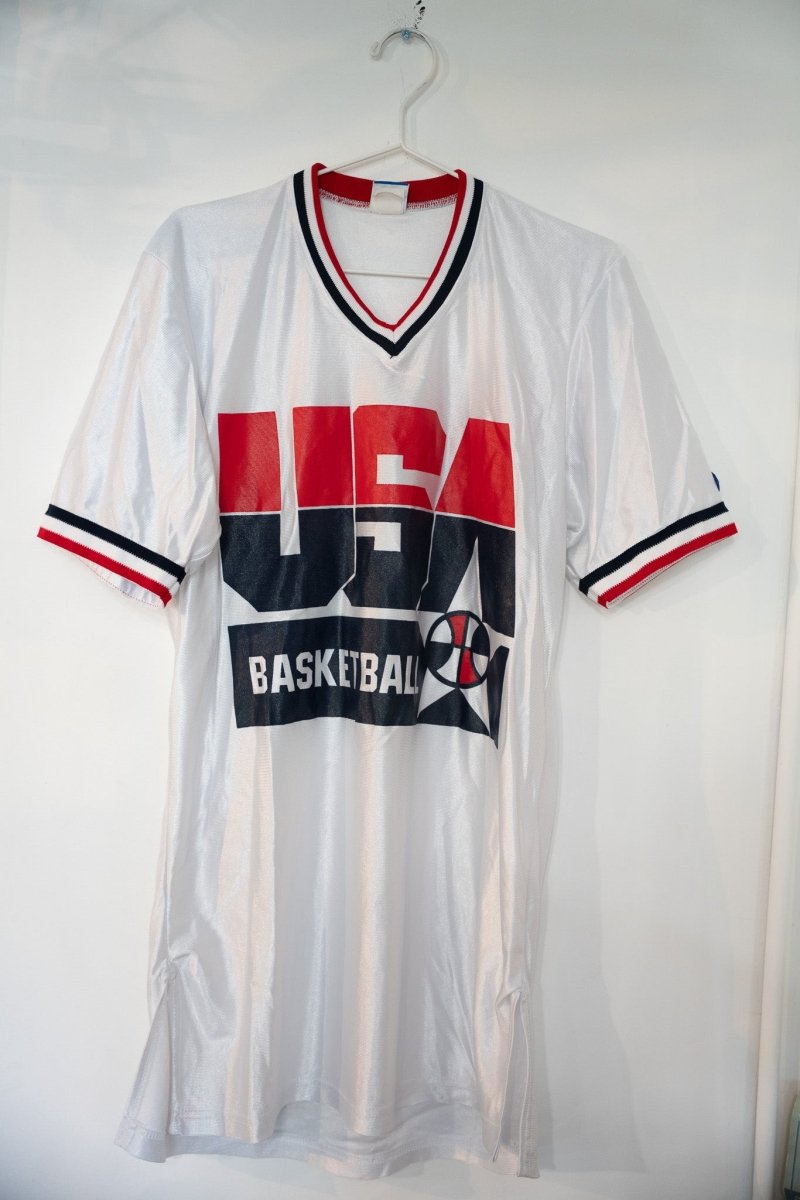 White 1992 Champion Team USA Basketball mesh warm-up jersey with large red navy USA lettering striped V-neck collar and sleeve cuffs size Medium
