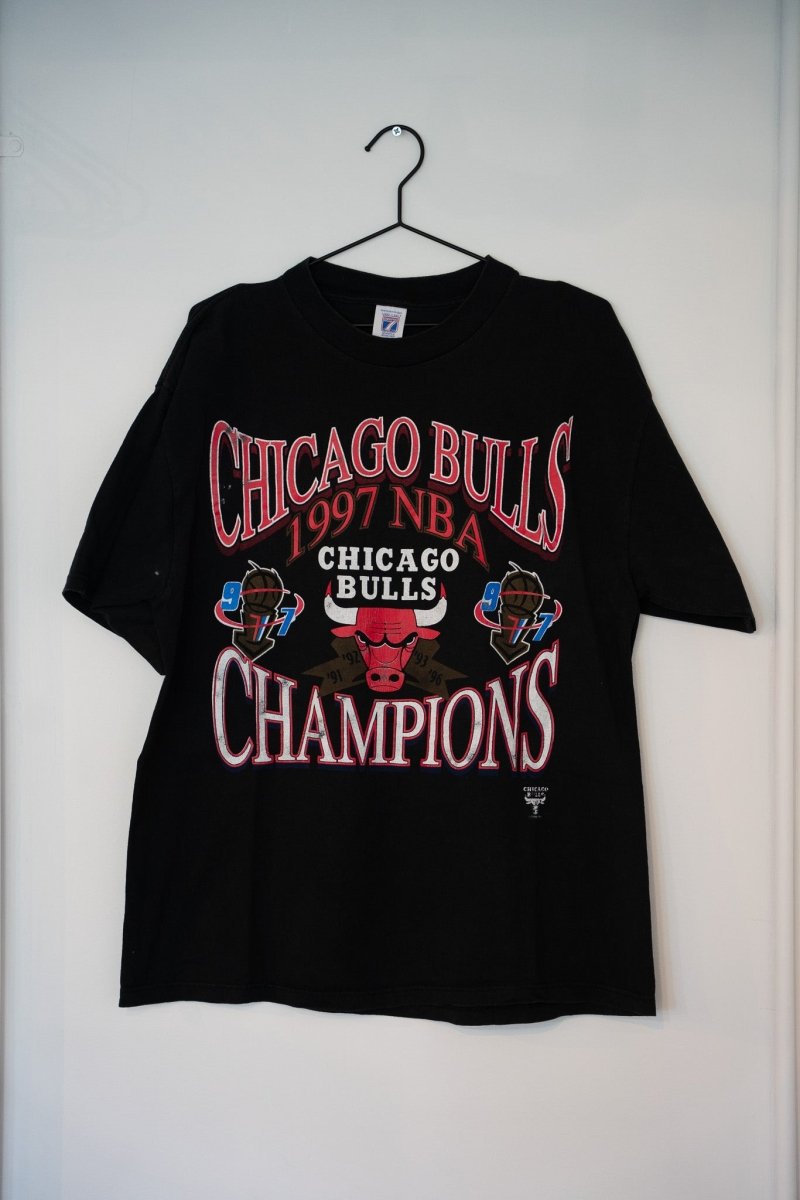 Black 1997 Logo 7 Chicago Bulls NBA Champions tee red CHICAGO BULLS text Bulls logo gold CHAMPIONS lettering 91 92 93 96 97 years size XL