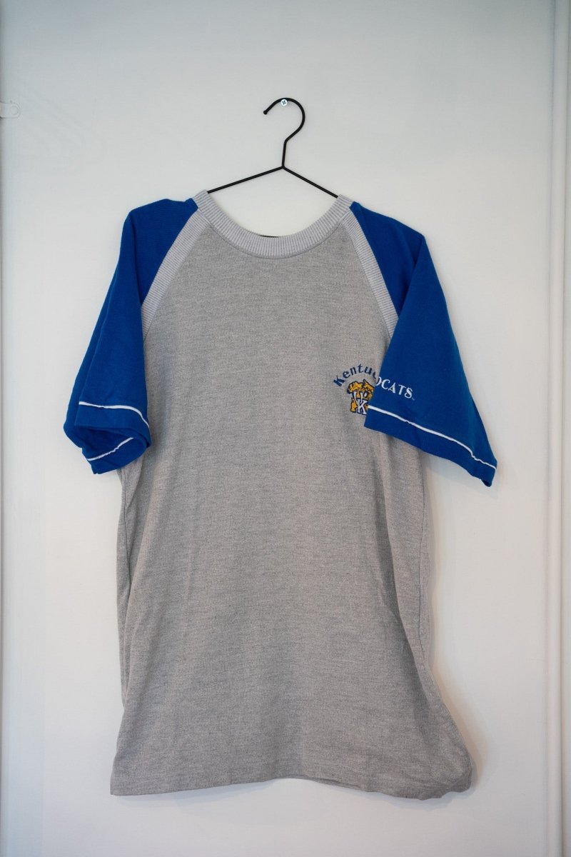 Gray and blue 90s Kentucky Wildcats raglan tee embroidered Kentucky Cats wildcat logo left chest blue raglan sleeves white piping