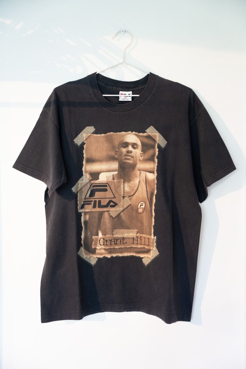 Black 90s FILA Grant Hill graphic tee with sepia-toned torn-paper portrait Pistons 33 jersey FILA logo Grant Hill handwritten text size Medium