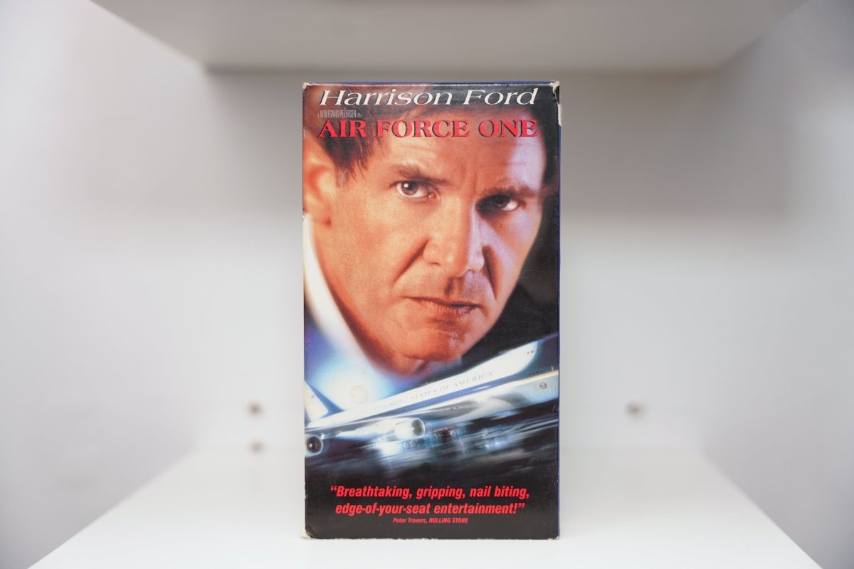 Air Force One VHS cover with Harrison Ford intense close-up and presidential Boeing 747, Rolling Stone quote