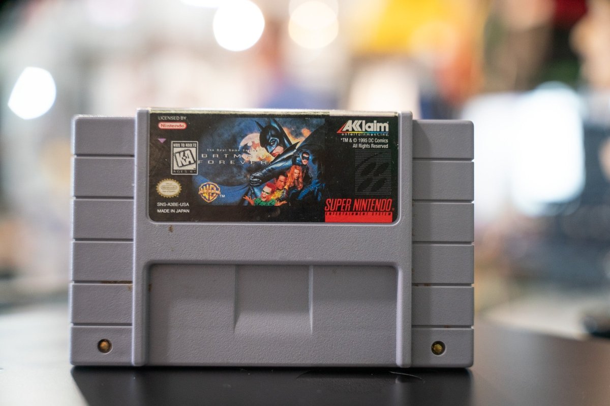 Acclaim Batman Forever Super Nintendo SNES cartridge from 1995, black plastic game case with red label featuring Batman character artwork and game title