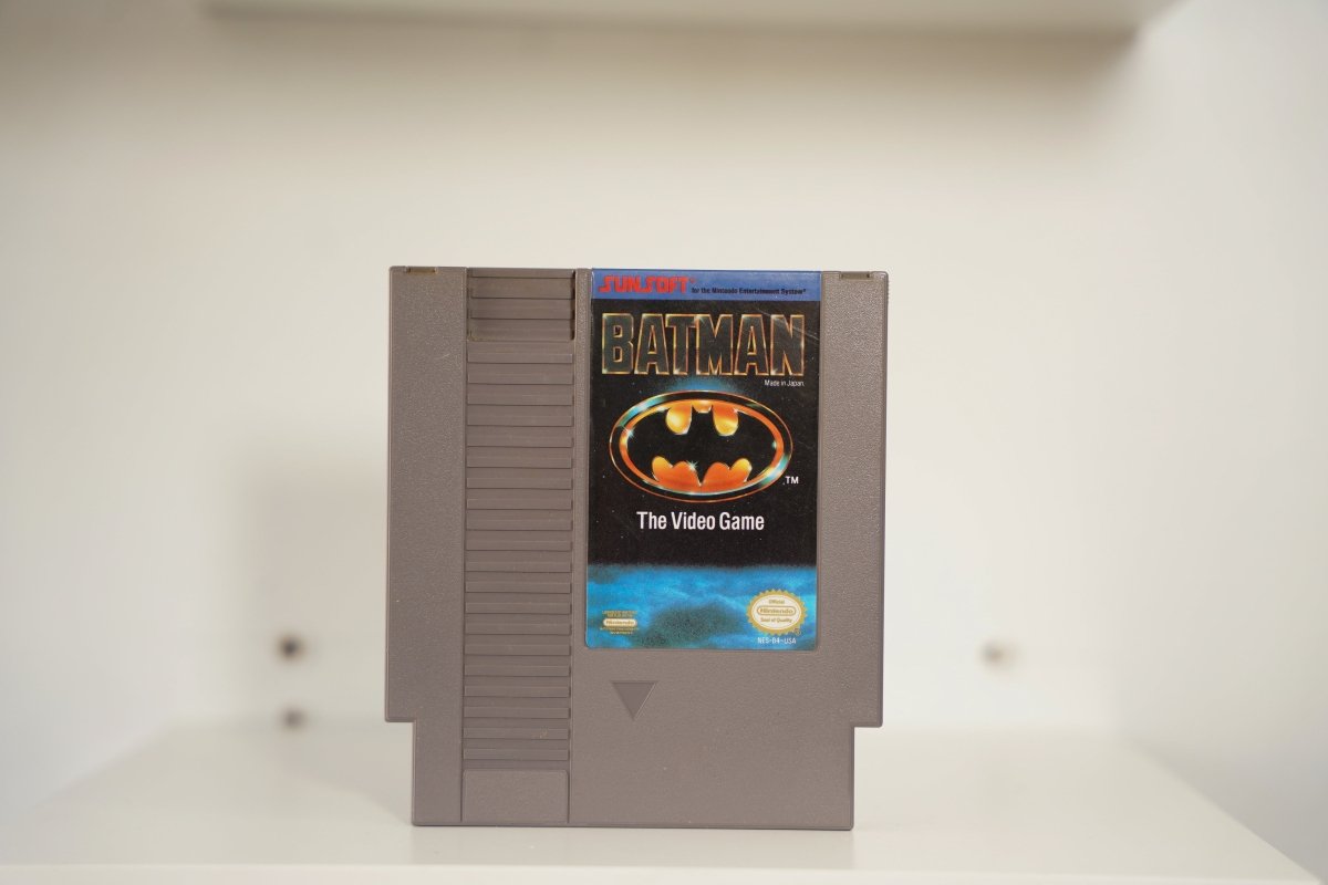 NES Batman The Video Game gray cartridge Batman logo orange gold black background SUNSOFT red BATMAN gold text Nintendo Seal Made in Japan