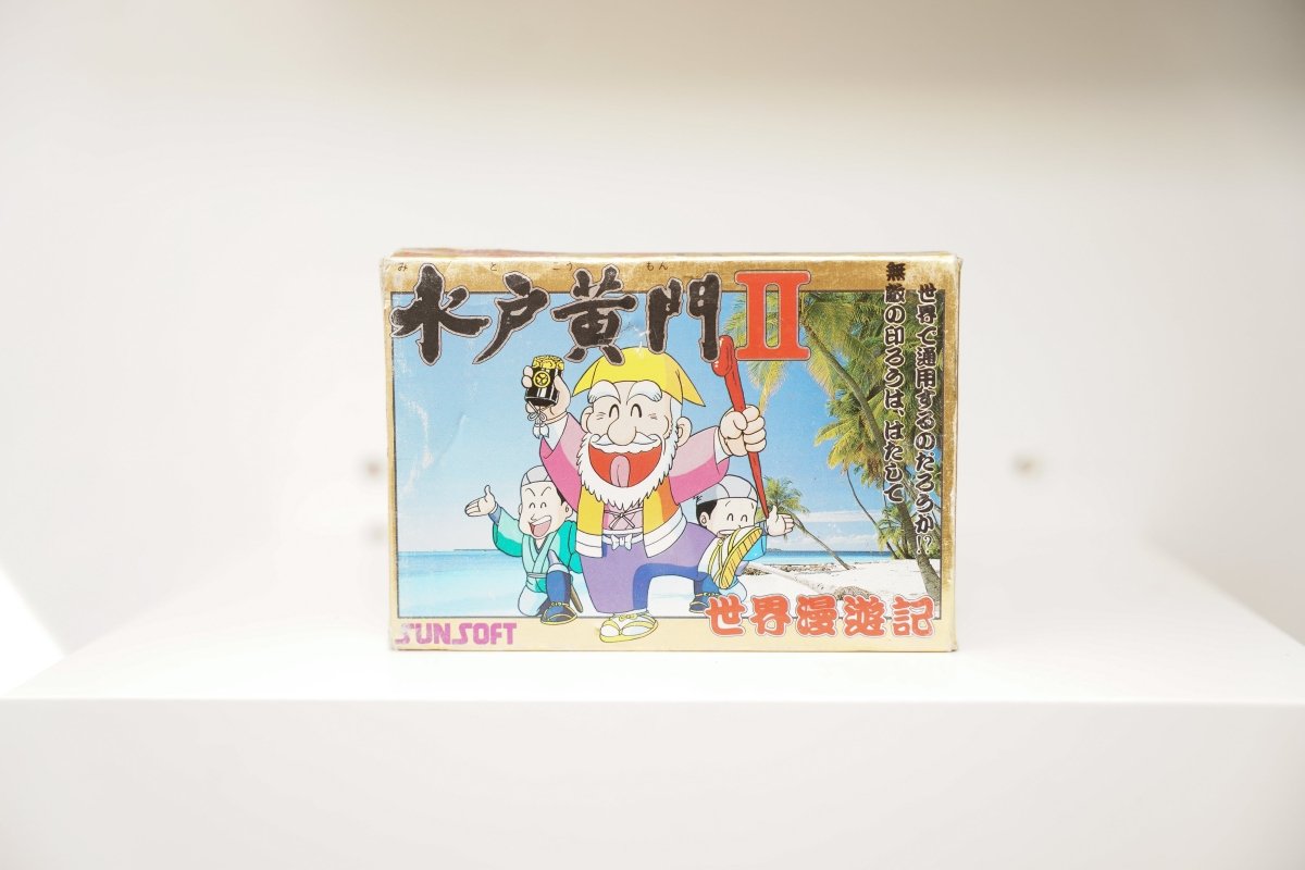 Nintendo Famicom Mito Koumon II box cartoon elderly man purple robes two companions beach palm trees Mito Koumon II kanji Sunsoft logo