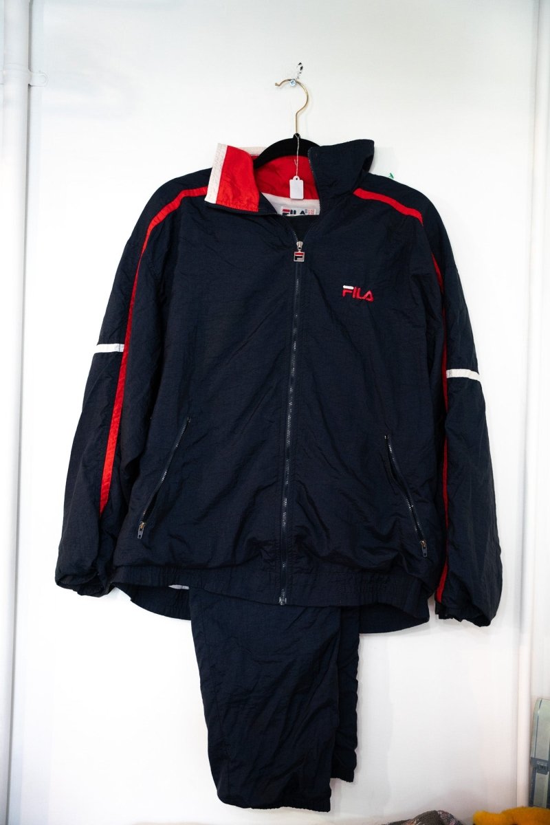 Navy Fila two-piece windbreaker tracksuit with red piping white accent stripes embroidered FILA logo on jacket and matching track pants