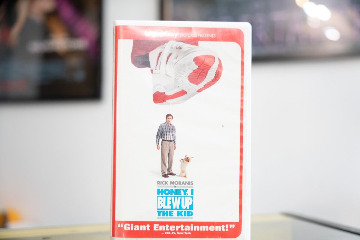 Honey I Blew Up the Kid VHS white sleeve with red border giant red sneaker above tiny Rick Moranis blue title lettering and Disney Pictures banner