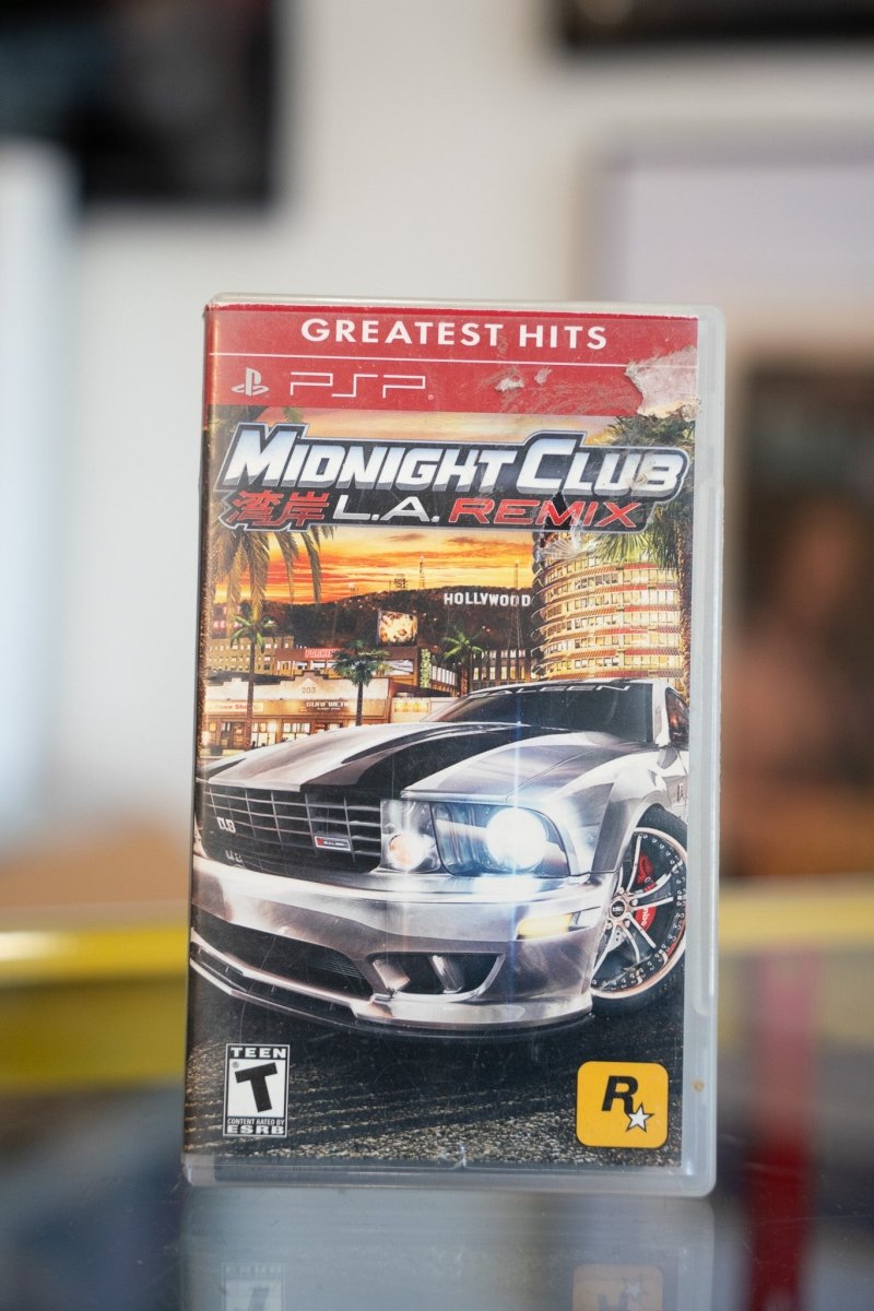 Midnight Club LA Remix PSP Greatest Hits game in red banner case with silver muscle car and Hollywood skyline cover art