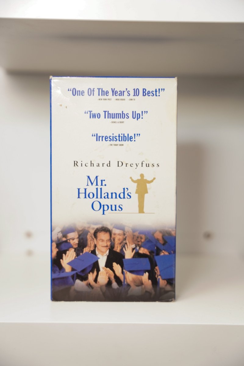 VHS Mr. Holland's Opus Richard Dreyfuss glasses graduates blue caps gowns gold conductor silhouette Year's 10 Best Two Thumbs Up Mr. Holland's Opus blue text