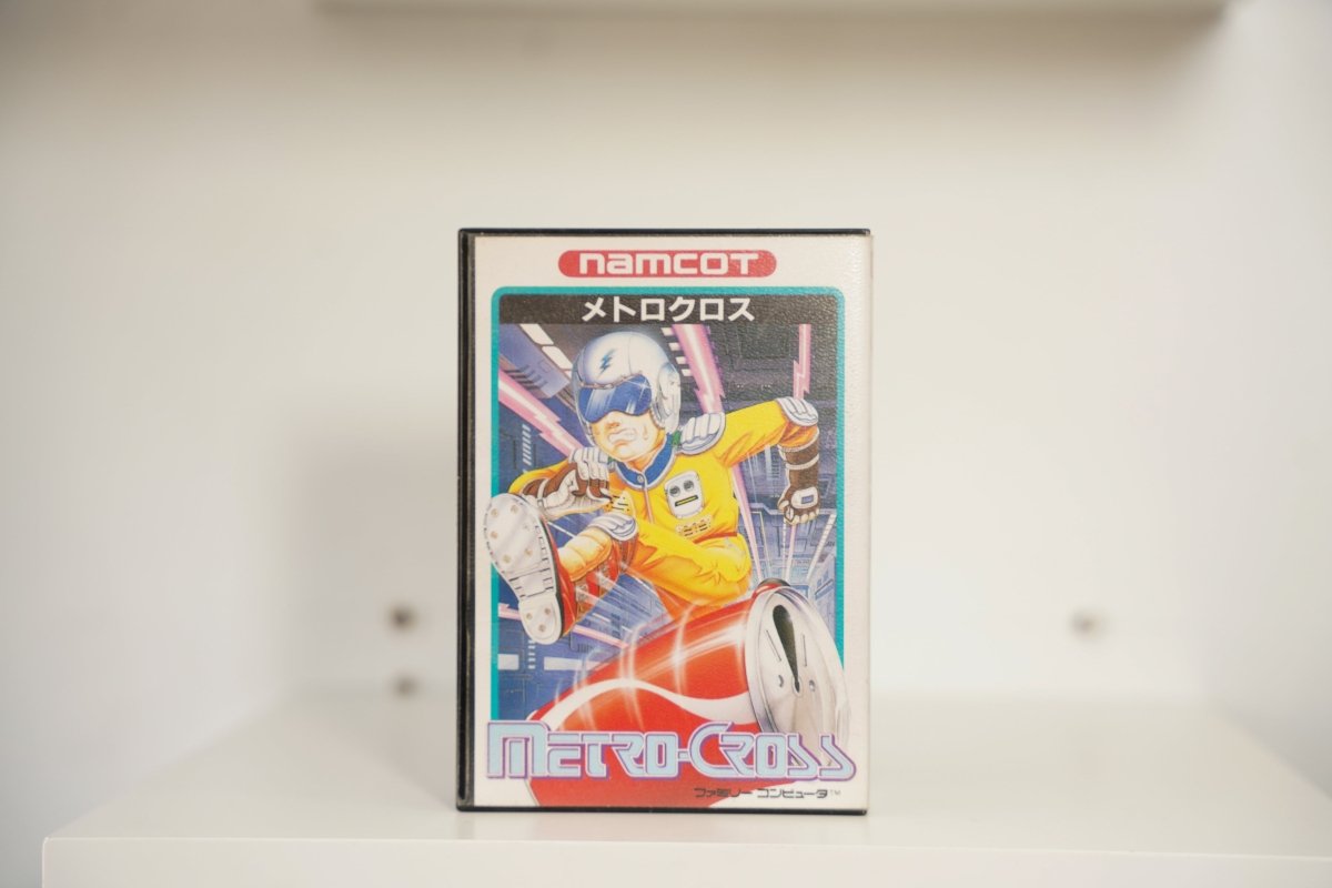 Nintendo Famicom Metro-Cross box teal border futuristic runner yellow jumpsuit blue helmet lightning bolt clock METRO-CROSS red white text namcot