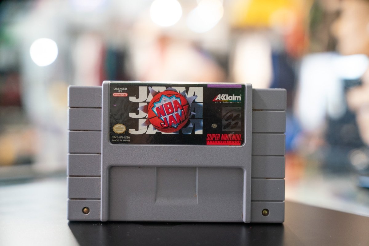 Acclaim NBA Jam cartridge for Super Nintendo SNES, 1994 release, showing the game's colorful label artwork featuring basketball players and flames