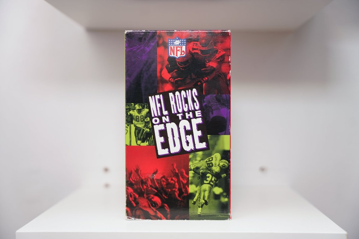 VHS NFL Rocks on the Edge NFL shield logo football action concert crowd purple red green tint NFL ROCKS ON THE EDGE white text