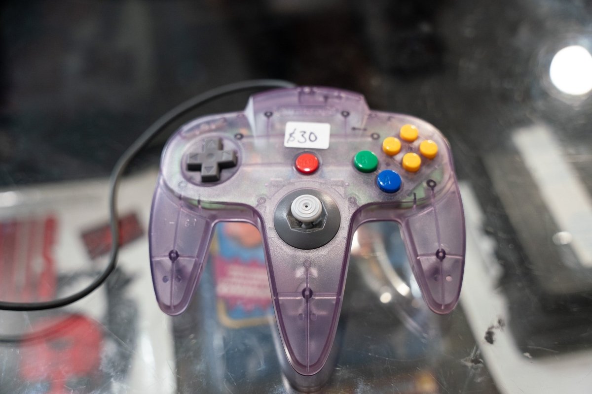 Nintendo 64 Atomic Purple clear translucent purple controller with visible internals analog stick D-pad yellow C-buttons red Start button