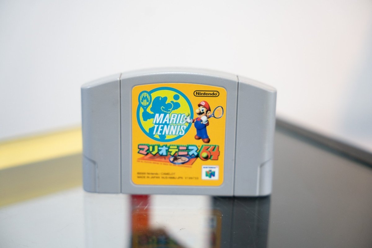 Nintendo 64 Mario Tennis 64 Japanese import cartridge gray with yellow orange label Mario swinging tennis racket blue globe Japanese katakana text