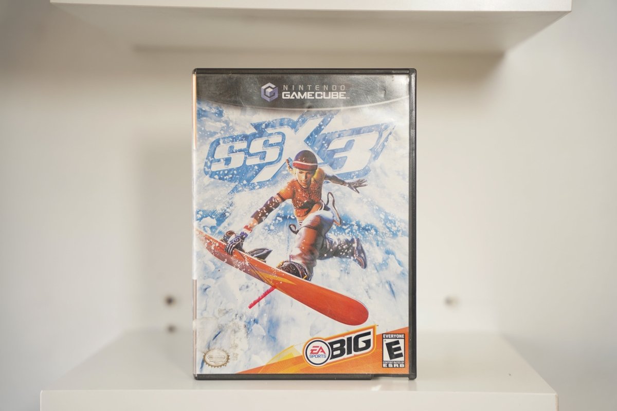 Nintendo GameCube SSX 3 case snowboarder mid-air orange outfit snow SSX 3 icy blue text mountain EA Sports BIG Everyone