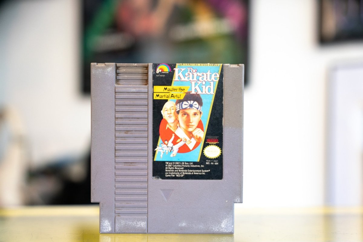 Nintendo NES The Karate Kid gray cartridge by LJN with Daniel LaRusso in red headband and Mr Miyagi on label with worn edges