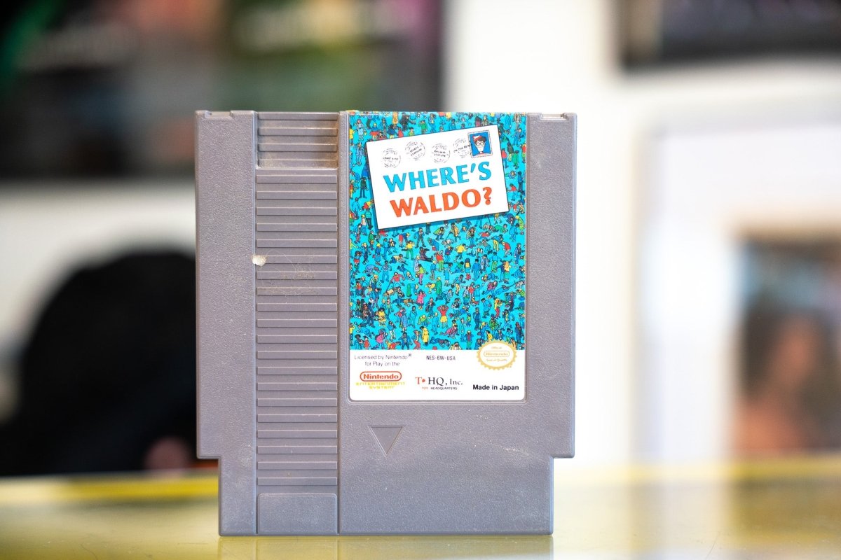 Nintendo NES Where's Waldo gray cartridge by THQ with classic crowded illustration art style and white postcard WHERE'S WALDO title banner