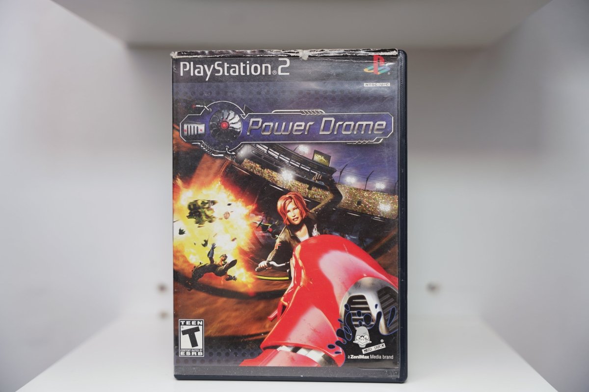 PS2 Power Drome case with red-haired pilot and futuristic red racing craft amid explosion, Mud Duck Productions ZeniMax Media brand logo