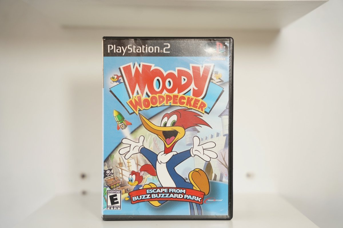 PS2 Woody Woodpecker Escape from Buzz Buzzard Park case Woody red crest grin theme park castle WOODY WOODPECKER text DreamCatcher Everyone