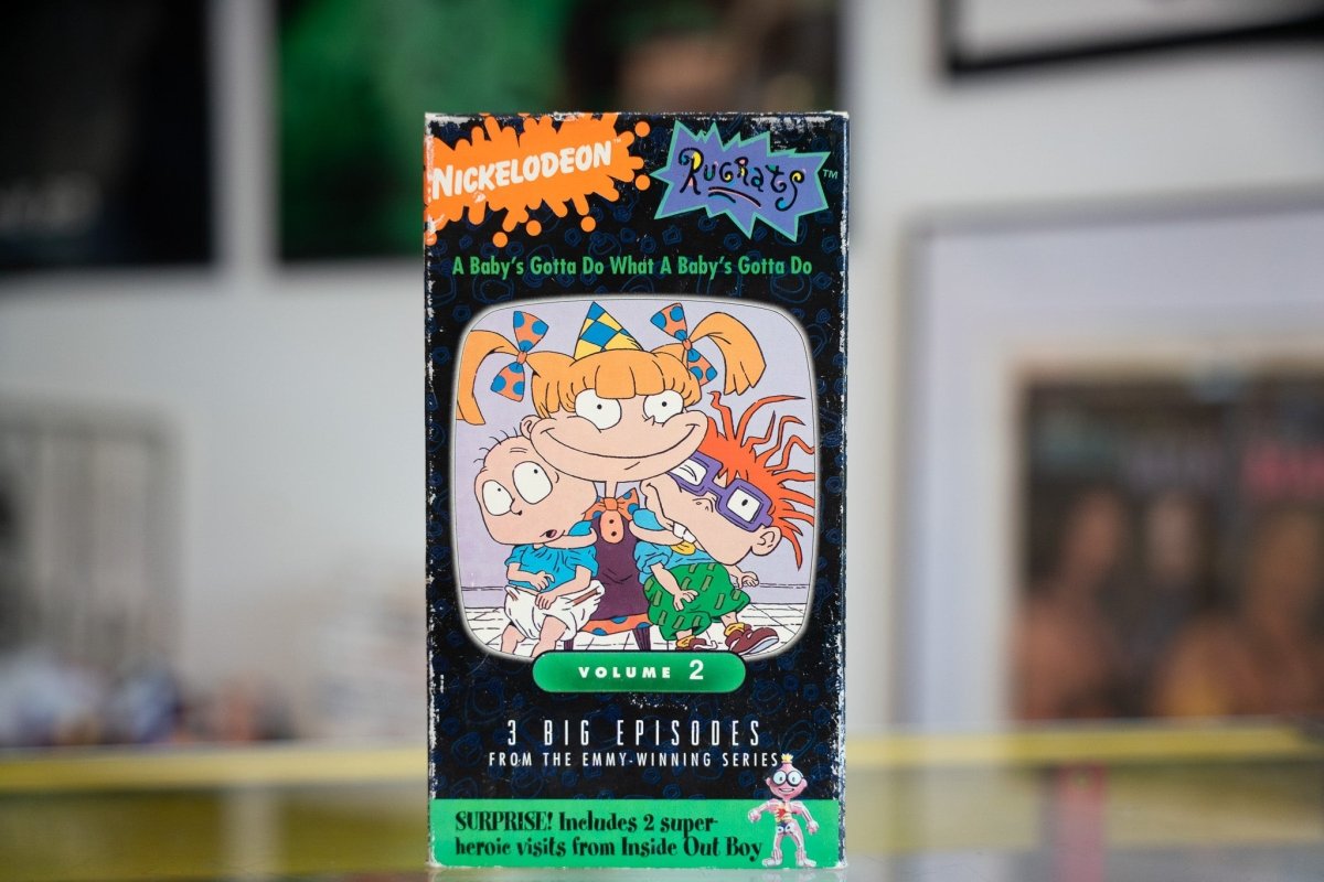 Rugrats A Baby's Gotta Do What A Baby's Gotta Do VHS cassette tape from 1990s Nickelodeon animated series, showing colorful cartoon baby characters on yellow packaging