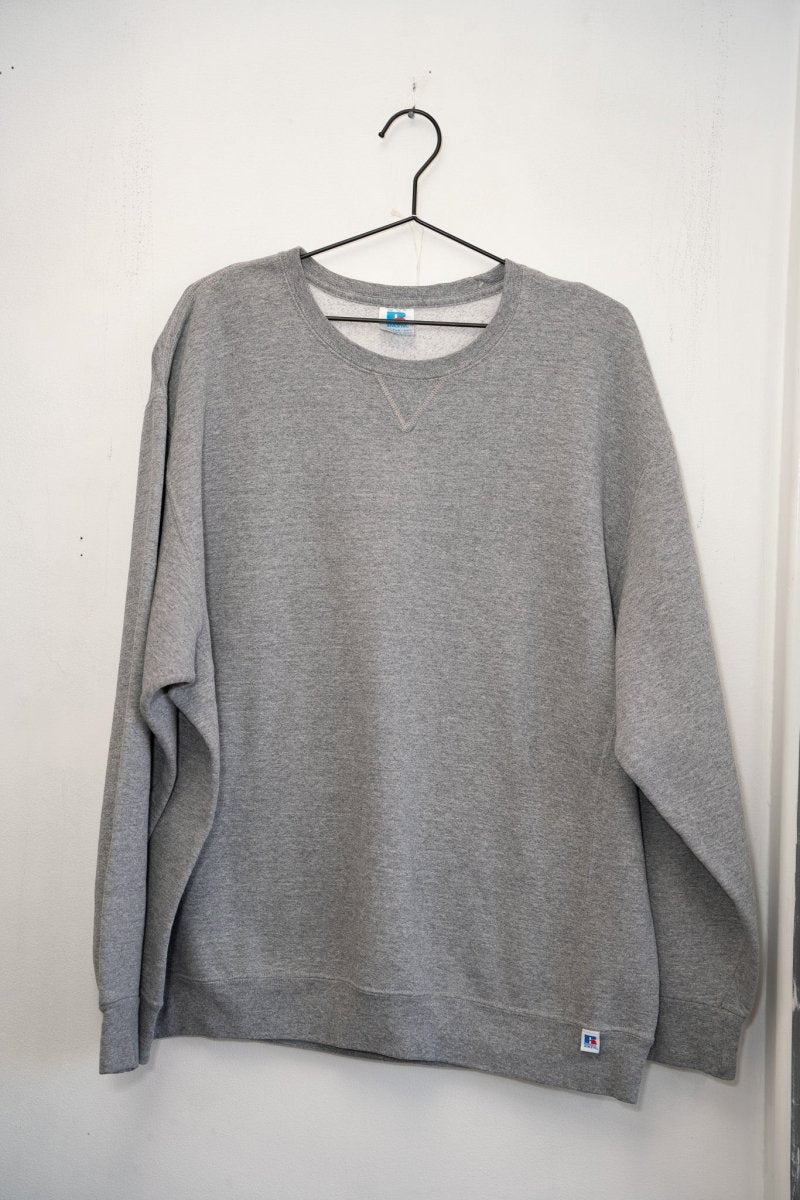 Heather gray Russell Athletic blank crewneck sweatshirt V-notch detail Russell R tag blue woven patch lower hem ribbed cuffs