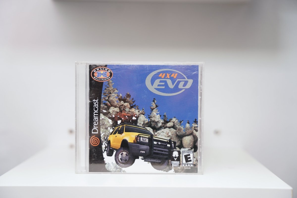 Sega Dreamcast 4x4 EVO jewel case with yellow SUV on rocky terrain, Online Multi-Player badge, Terminal Reality logo, blue sky background