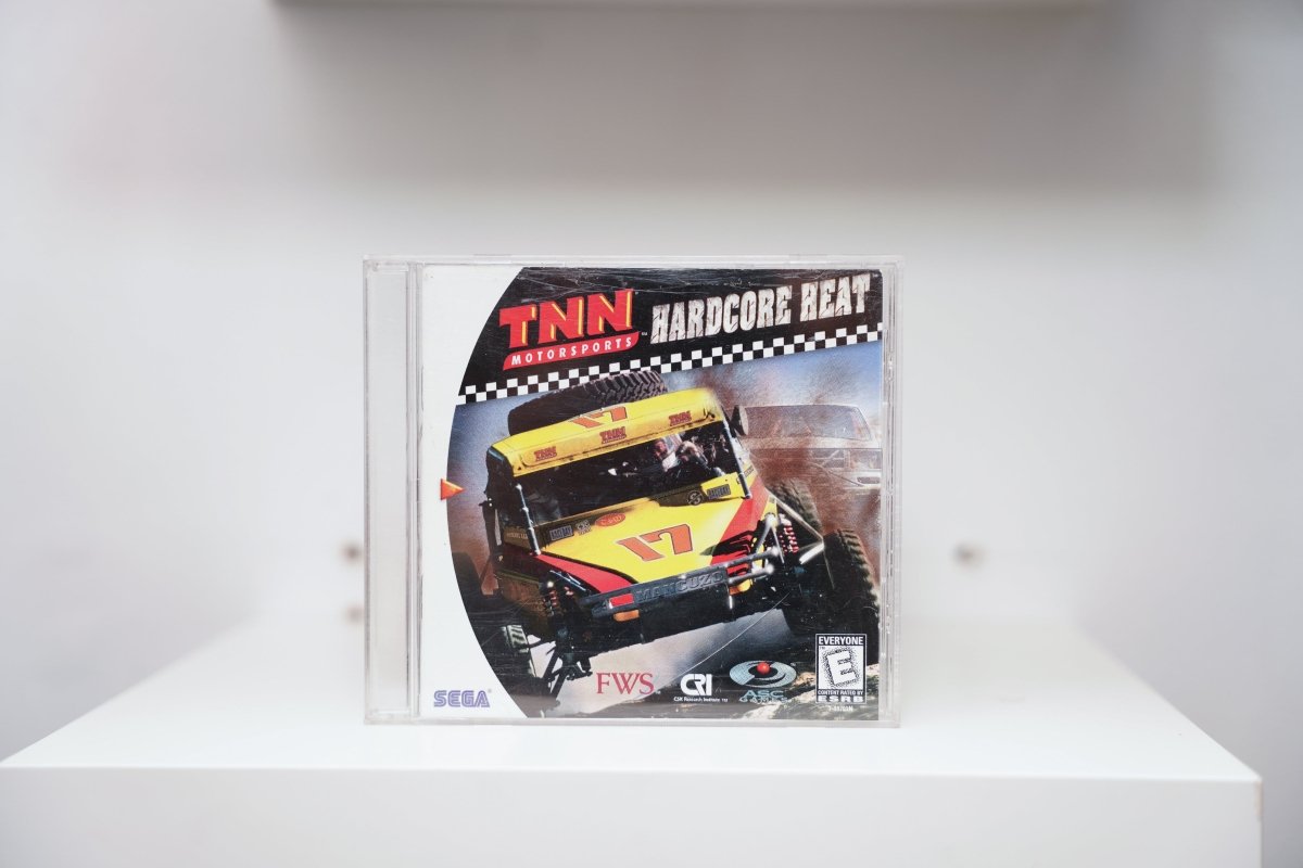 Sega Dreamcast TNN Motorsports Hardcore Heat jewel case with yellow off-road racing buggy in dirt, checkered flag banner, Sega and ASC logos