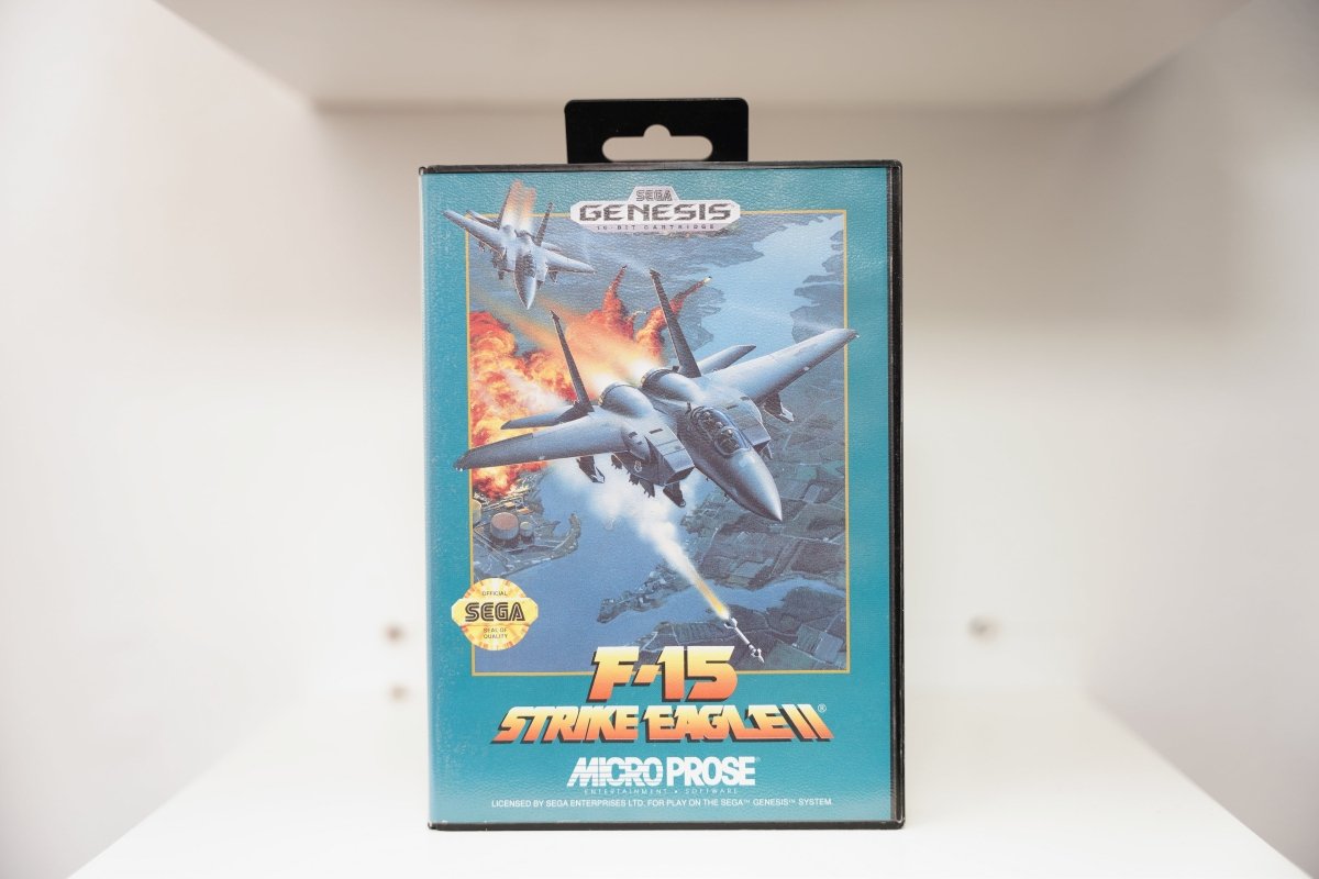 Sega Genesis F-15 Strike Eagle II case with painted F-15 fighter jets in combat, explosions below, MicroProse logo, Sega Genesis 16-Bit banner