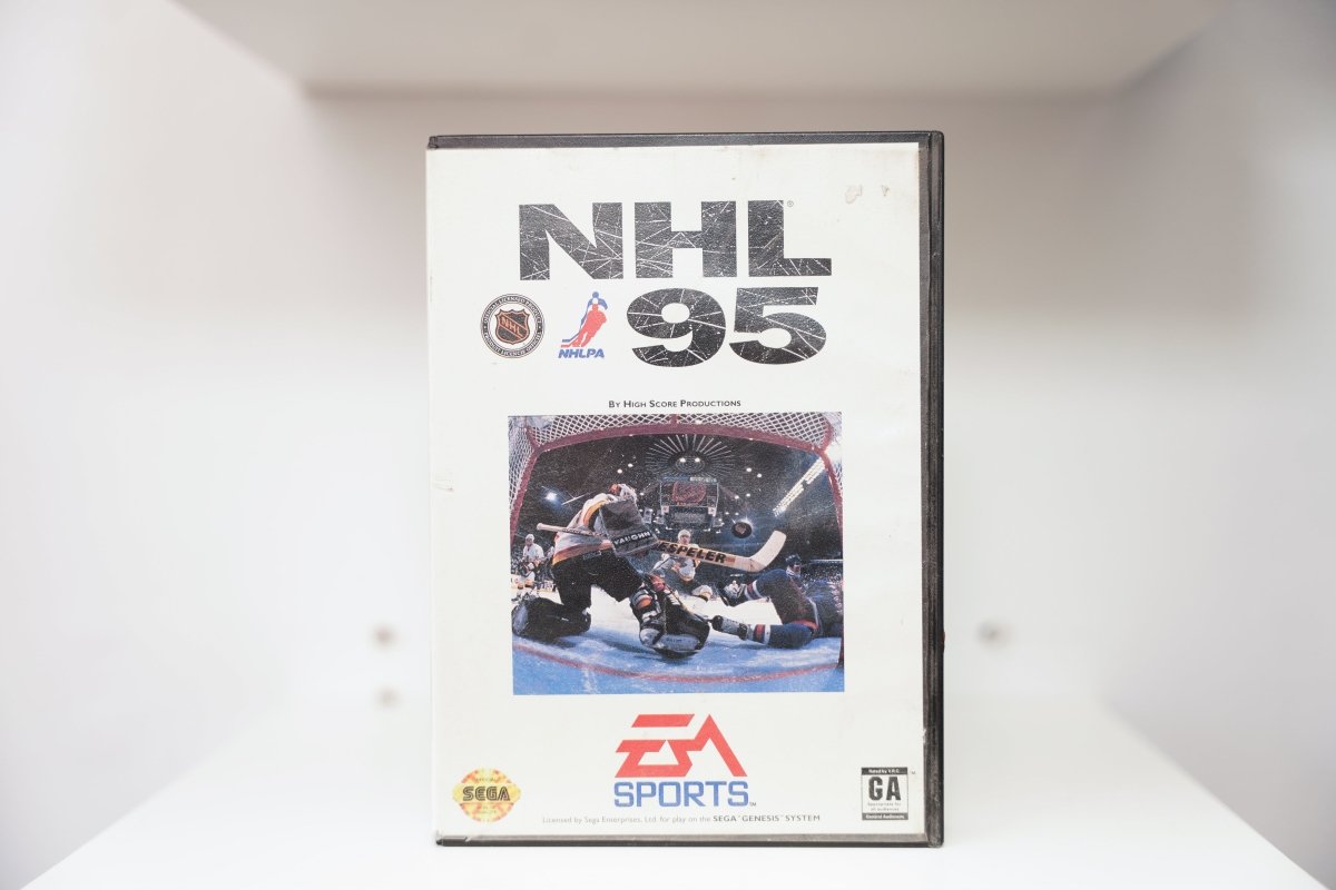 Sega Genesis NHL 95 case with hockey goalie making save, NHL and NHLPA logos, EA Sports logo, case shows wear and scuffing