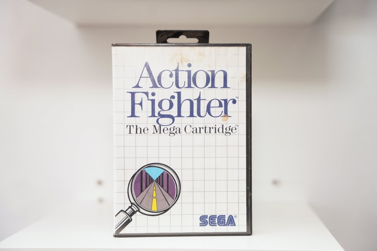 Sega Master System Action Fighter clamshell case with magnifying glass road illustration, The Mega Cartridge subtitle, some cover discoloration