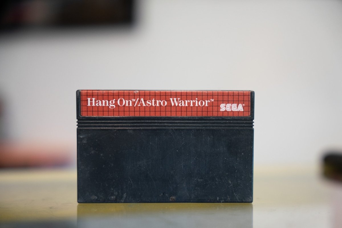 Sega Master System Hang-On Astro Warrior black cartridge with red label strip white title text and Sega logo