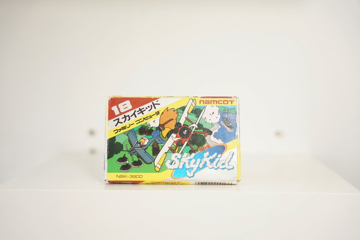 Nintendo Famicom Sky Kid first version box colorful biplanes red blue countryside 18 red text Sky Kid cloud lettering namcot logo