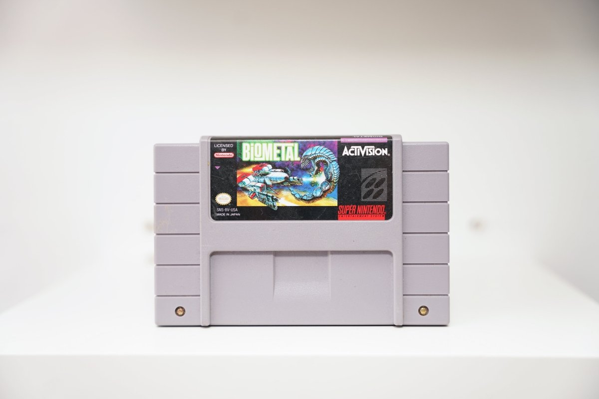 SNES BioMetal grey cartridge with spacecraft battling bio-mechanical alien creature in space, Activision logo, Made in Japan
