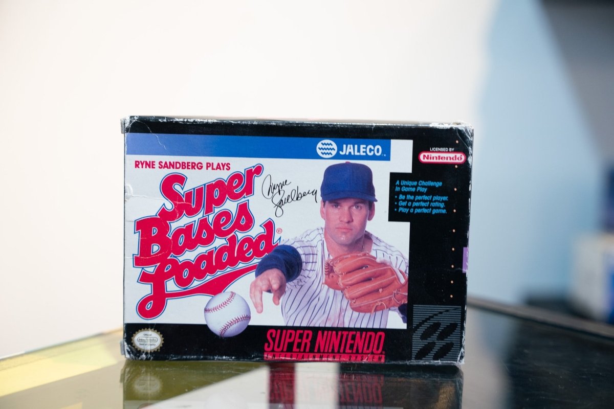 SNES Ryne Sandberg Plays Super Bases Loaded box with Sandberg in Cubs pinstripes holding baseball and glove, Jaleco logo, signature