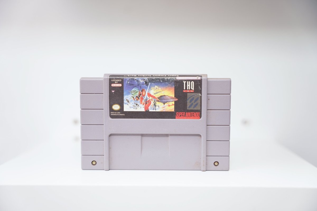 SNES Super Empire Strikes Back grey cartridge with Luke Skywalker, AT-AT walkers, Cloud City artwork, THQ logo
