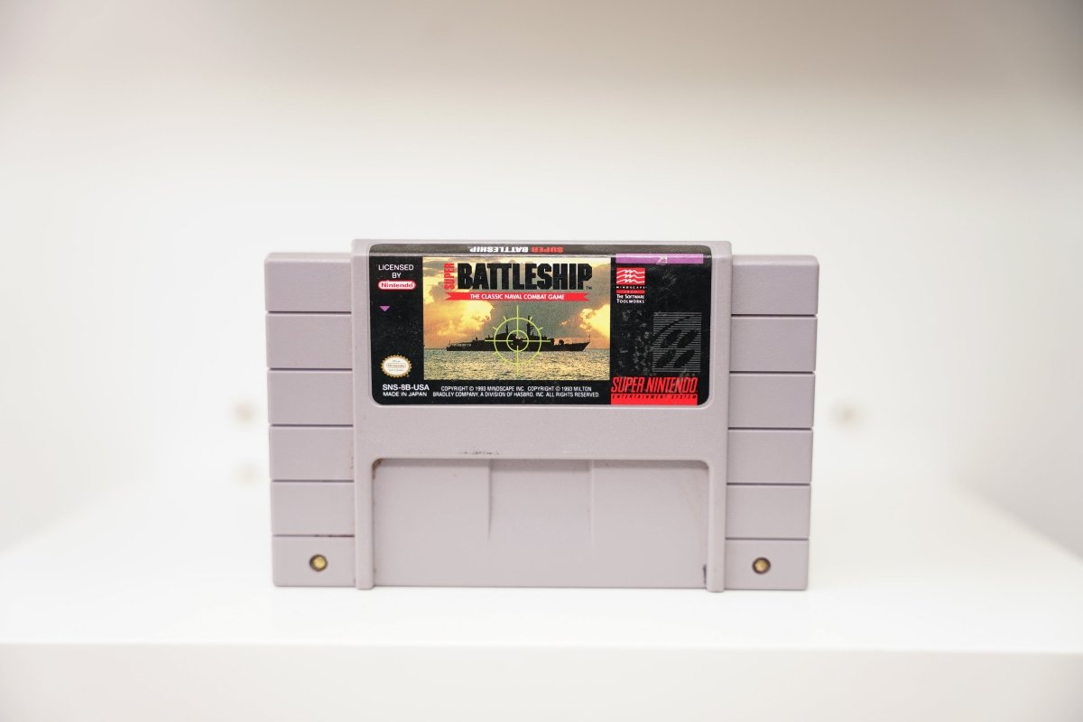 SNES Super Battleship grey cartridge with warship silhouette at sunset and targeting crosshair, Mindscape Software Toolworks logo