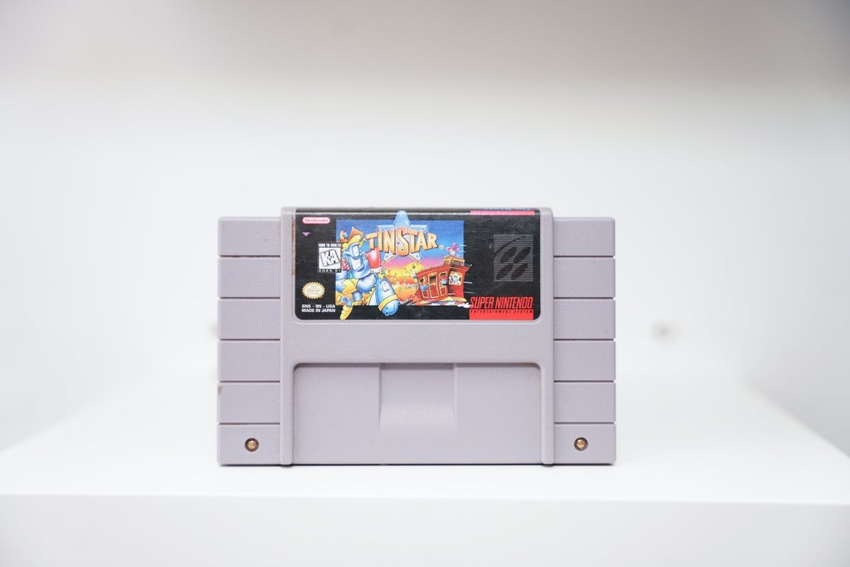 SNES Tin Star grey cartridge with cartoon robot sheriff cowboy in Wild West town, colorful artwork, Nintendo publisher