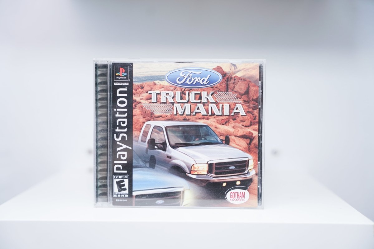 PS1 Ford Truck Mania CIB jewel case white Ford truck rocky terrain Ford blue oval TRUCK MANIA tire tread text Gotham Games Everyone