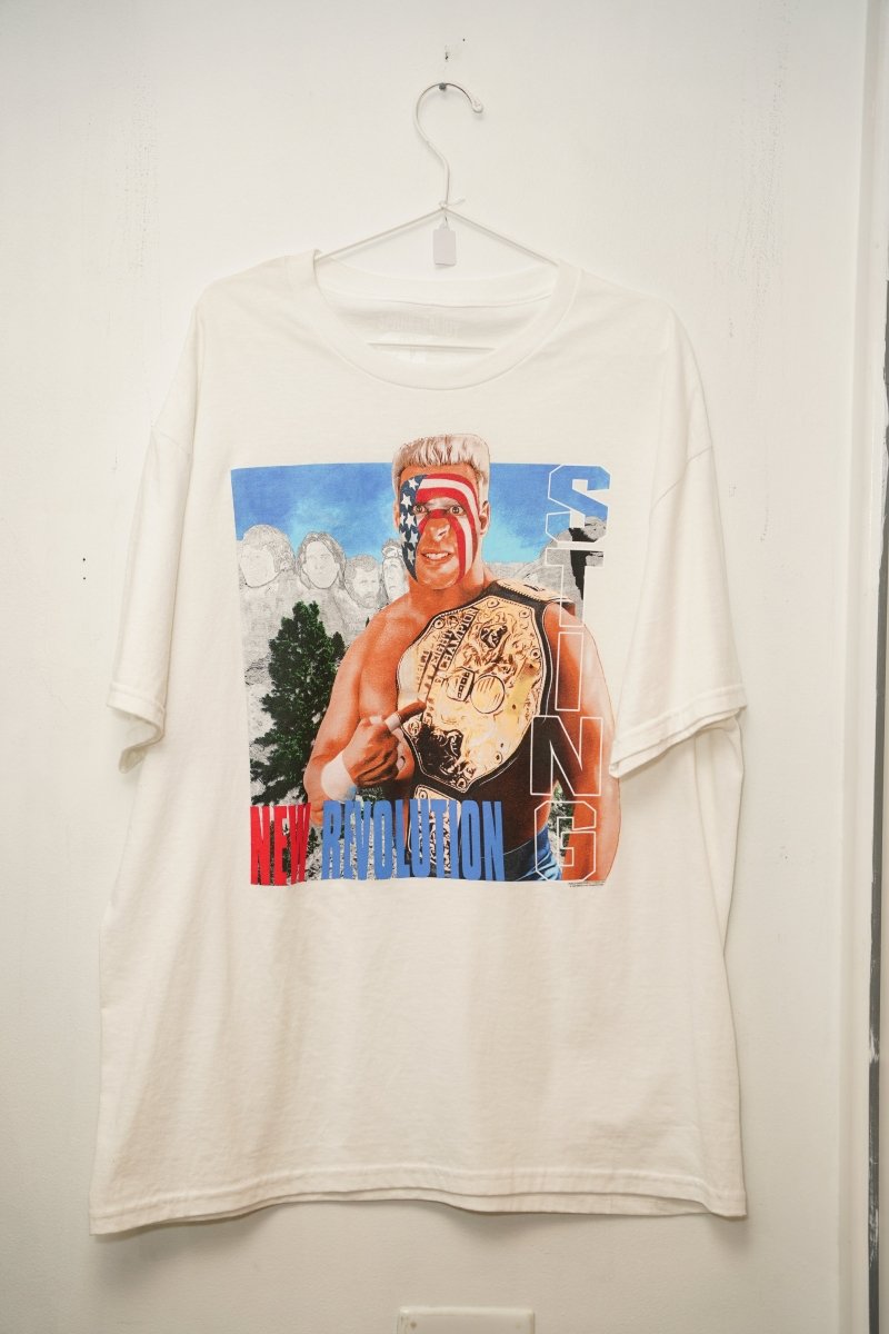 WCW Sting white New Revolution tee XL with Surfer Sting in American flag face paint holding championship belt, Mount Rushmore background, STING text