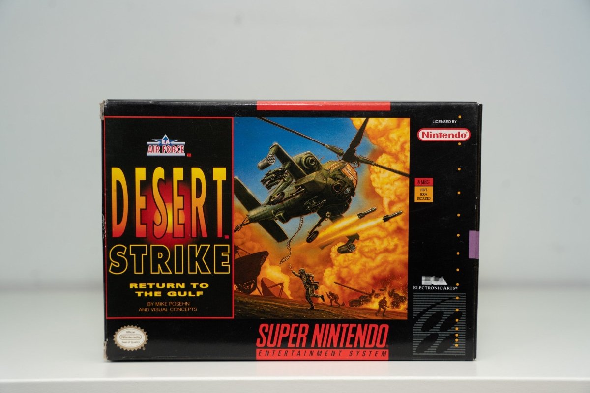 Super Nintendo Desert Strike Return to the Gulf box Apache helicopter missiles explosions desert DESERT STRIKE red text Electronic Arts Nintendo