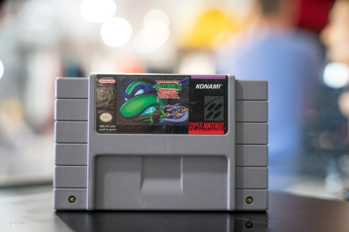 Nintendo Teenage Mutant Ninja Turtles Tournament Fighters SNES cartridge from 1993 with black label and game artwork visible