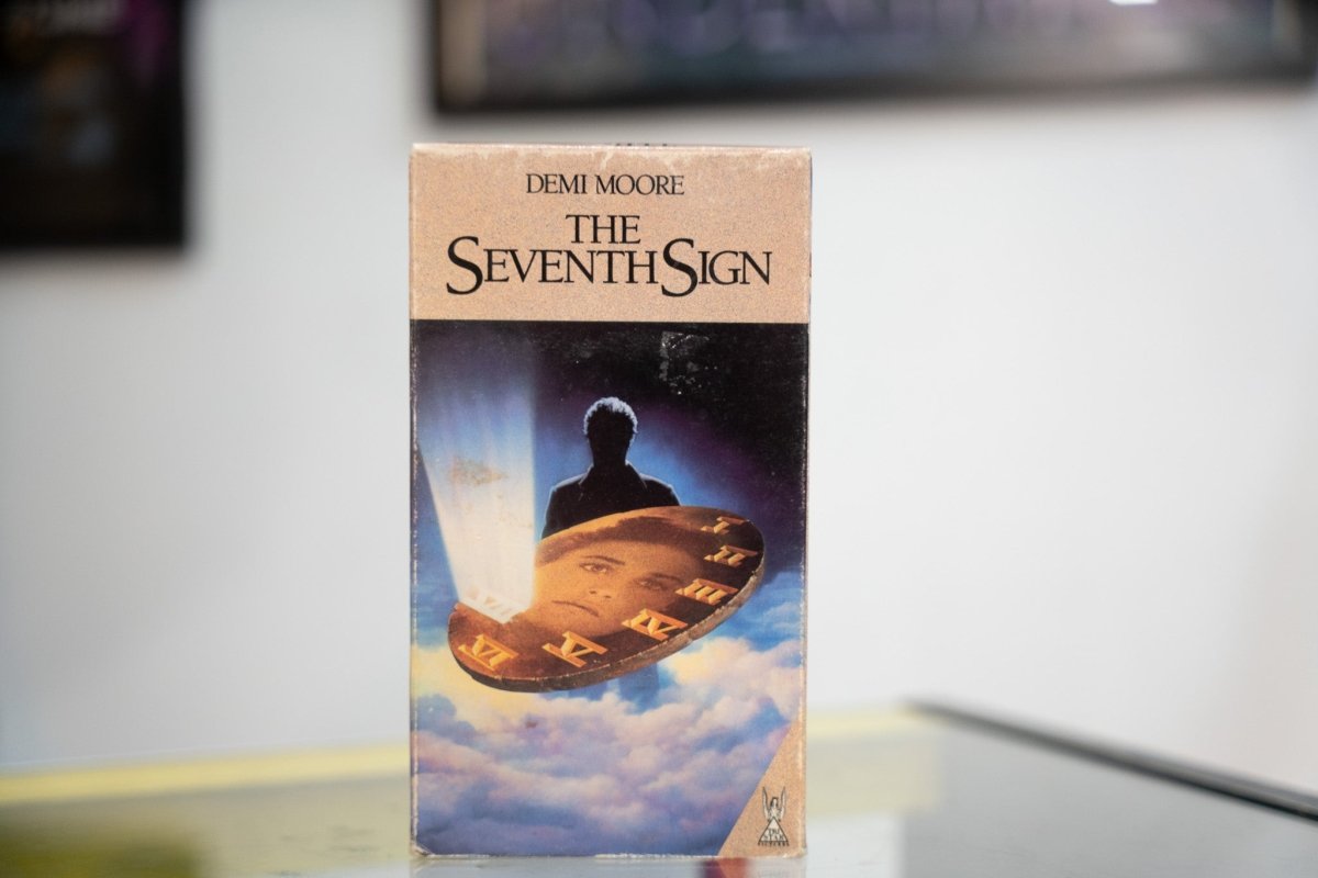 The Seventh Sign VHS tan sleeve with Demi Moore credit silhouetted figure divine light golden disc with Roman numerals in clouds