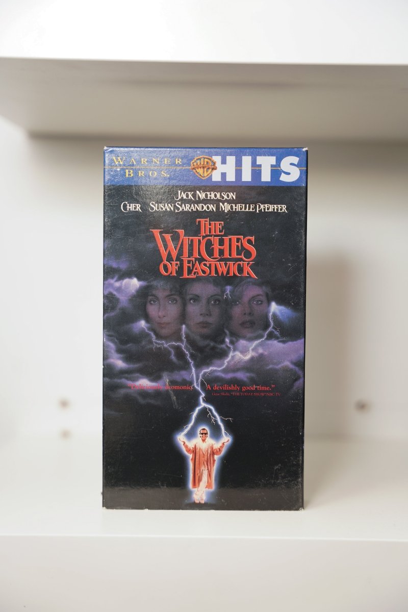 VHS Witches of Eastwick Warner Bros Hits dark stormy cover Cher Susan Sarandon Michelle Pfeiffer clouds Jack Nicholson lightning THE WITCHES OF EASTWICK text