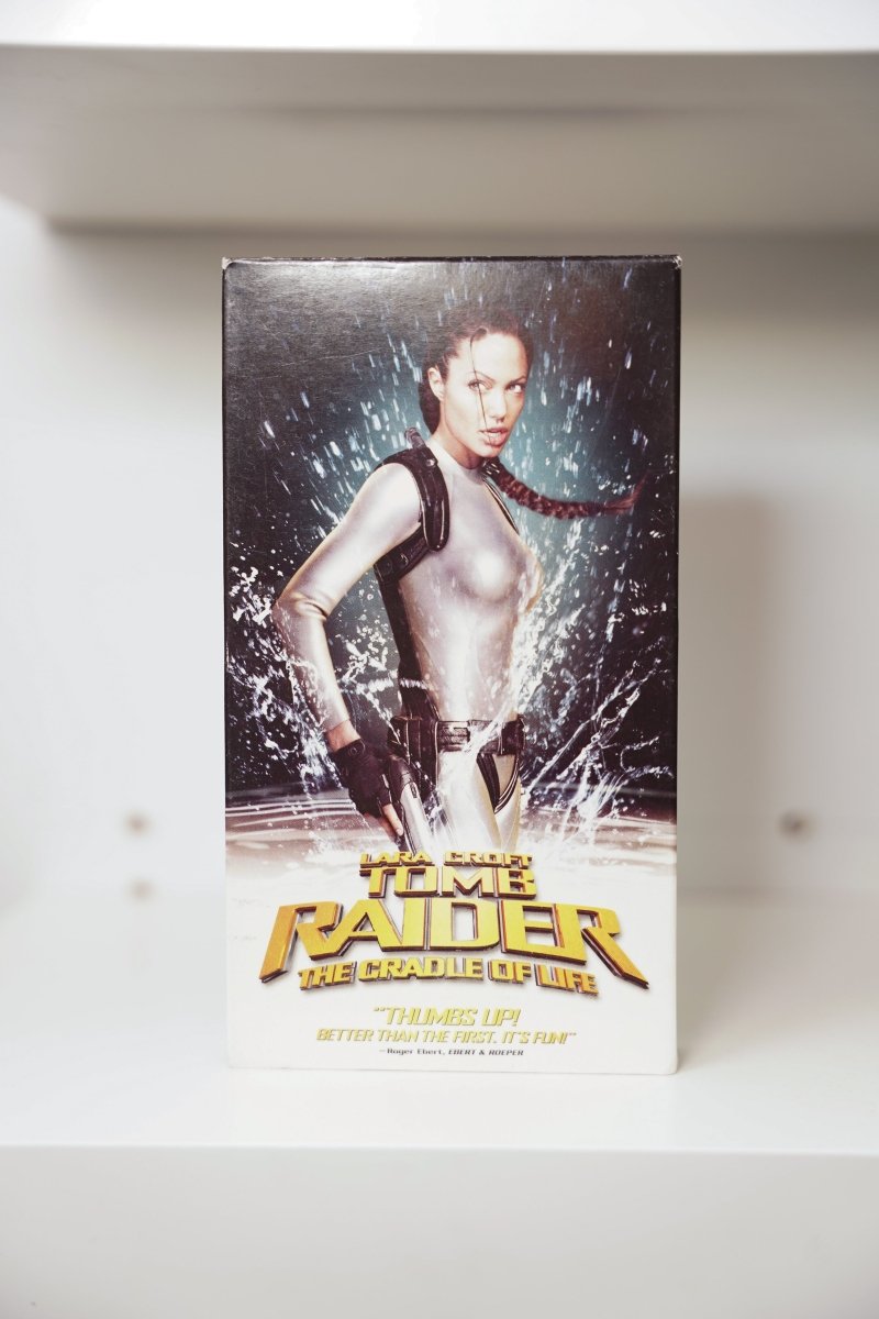 VHS Lara Croft Tomb Raider Cradle of Life Angelina Jolie silver wetsuit water dual pistols TOMB RAIDER gold text Ebert quote Paramount