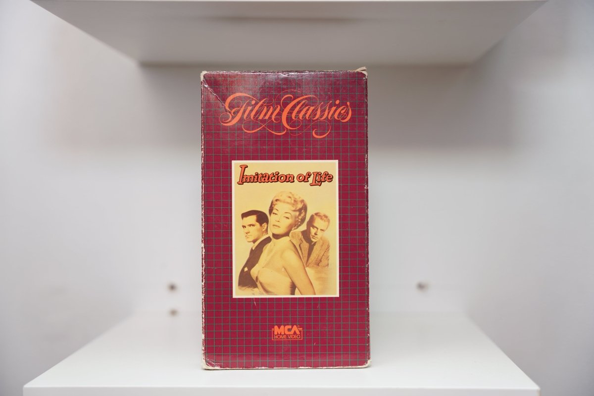 VHS Imitation of Life red plaid Film Classics cover sepia photo Lana Turner two men Imitation of Life red script text MCA Home Video