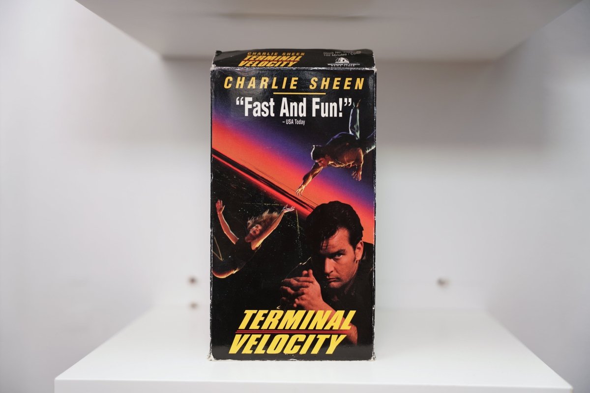 VHS Terminal Velocity dark cover Charlie Sheen close-up woman skydiving sunset sky CHARLIE SHEEN yellow text TERMINAL VELOCITY Paramount