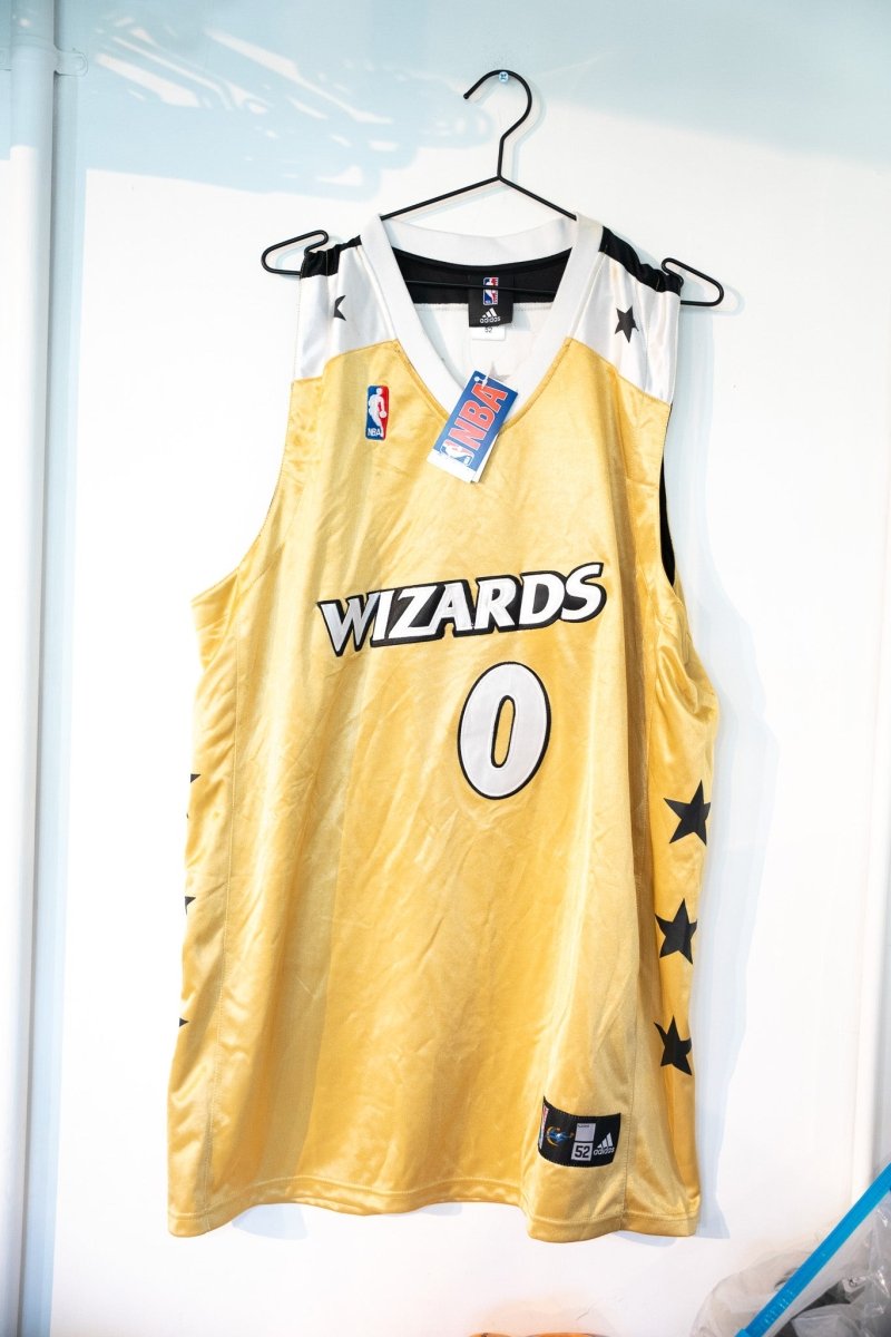 Gold vintage Adidas Washington Wizards Gilbert Arenas number 0 jersey with black stars white trim NBA hang tag NWT size XXL 52