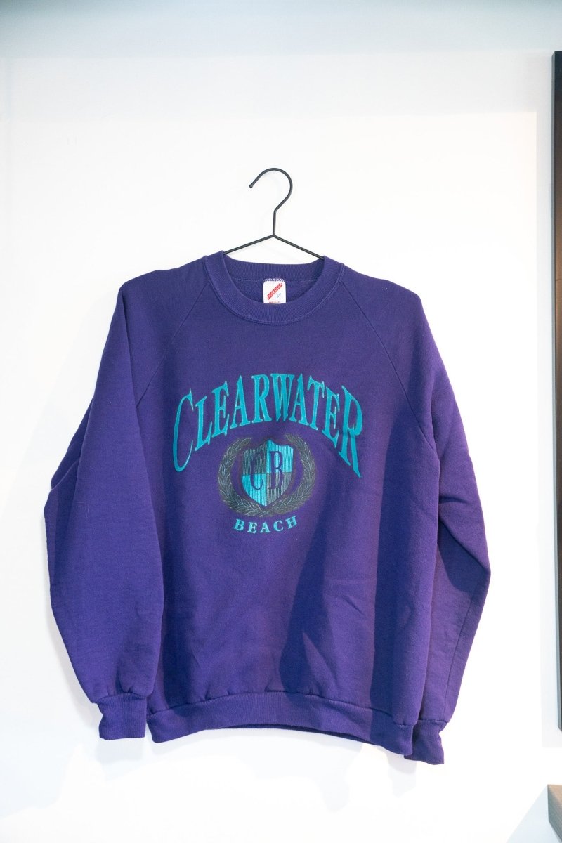 Deep purple vintage Clearwater Beach crewneck sweatshirt with teal CLEARWATER text CB shield crest laurel wreath BEACH lettering size Large