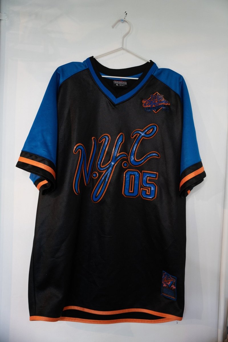 Black vintage FUBU NYC 05 mesh jersey with royal blue sleeves large blue orange NYC script lettering 05 number and FUBU City Series patch size XL