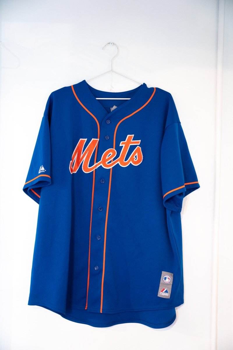 Royal blue Majestic New York Mets jersey orange Mets script text button-front orange piping MLB logo Majestic tag