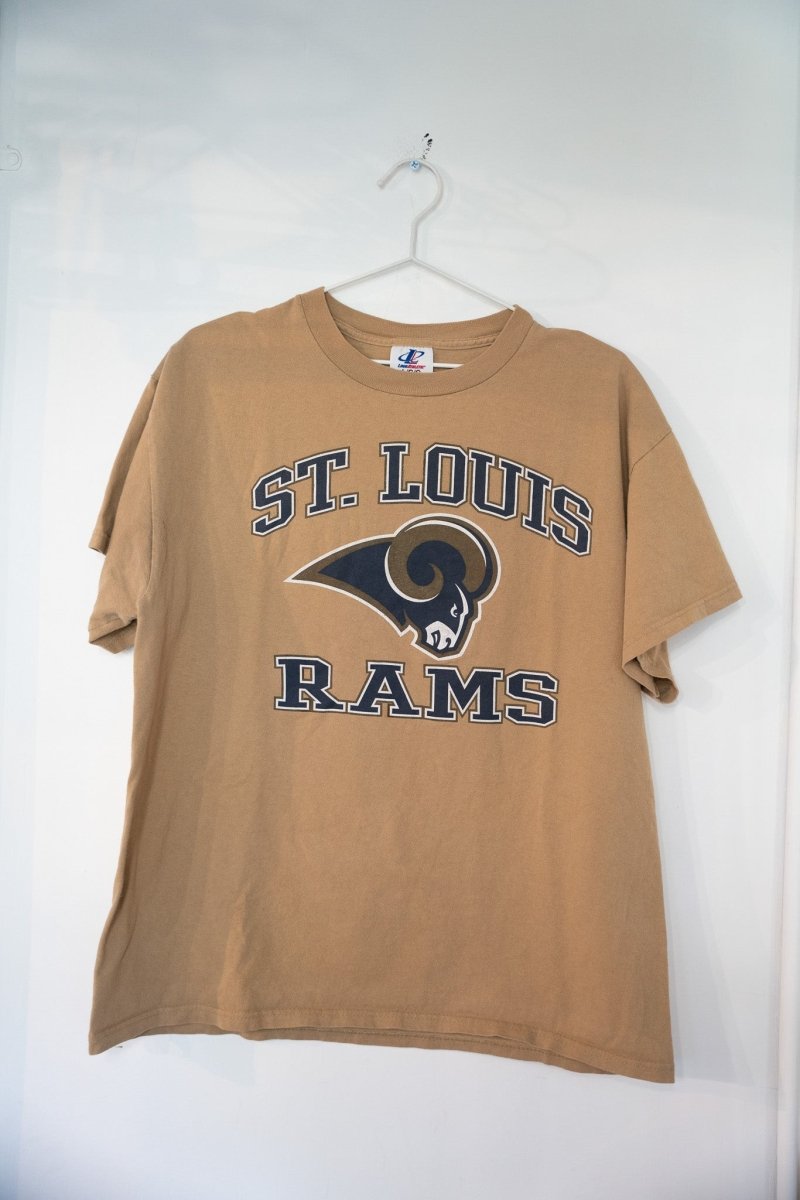 Tan khaki vintage St Louis Rams Logo Athletic t-shirt with navy arched ST LOUIS lettering ram head logo and navy RAMS text size Large